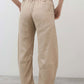Loose linen pants in light beige, relaxed fit with elastic waist and roomy straight legs