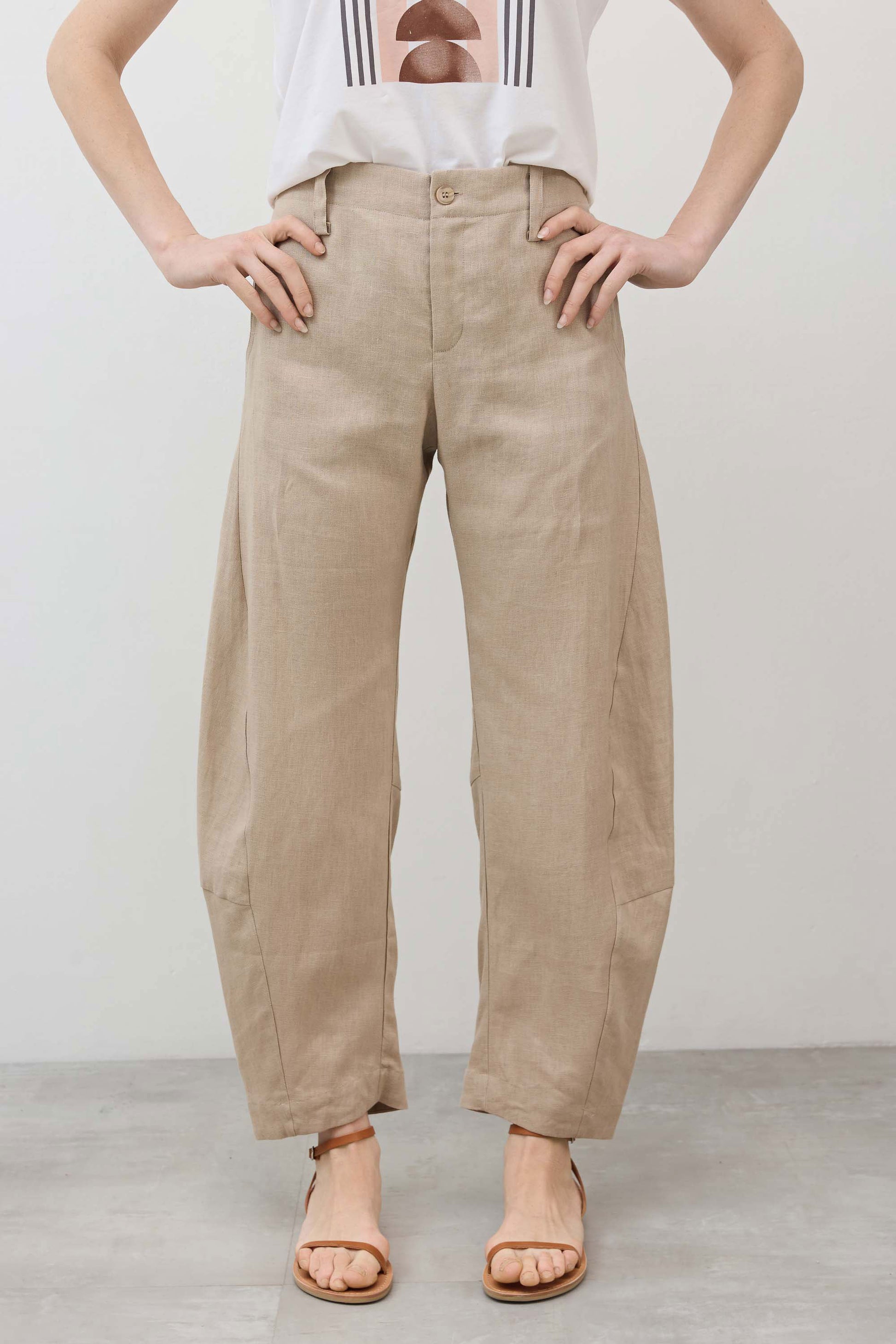 Light beige linen pants with buttoned front and elastic waist, wide relaxed legs