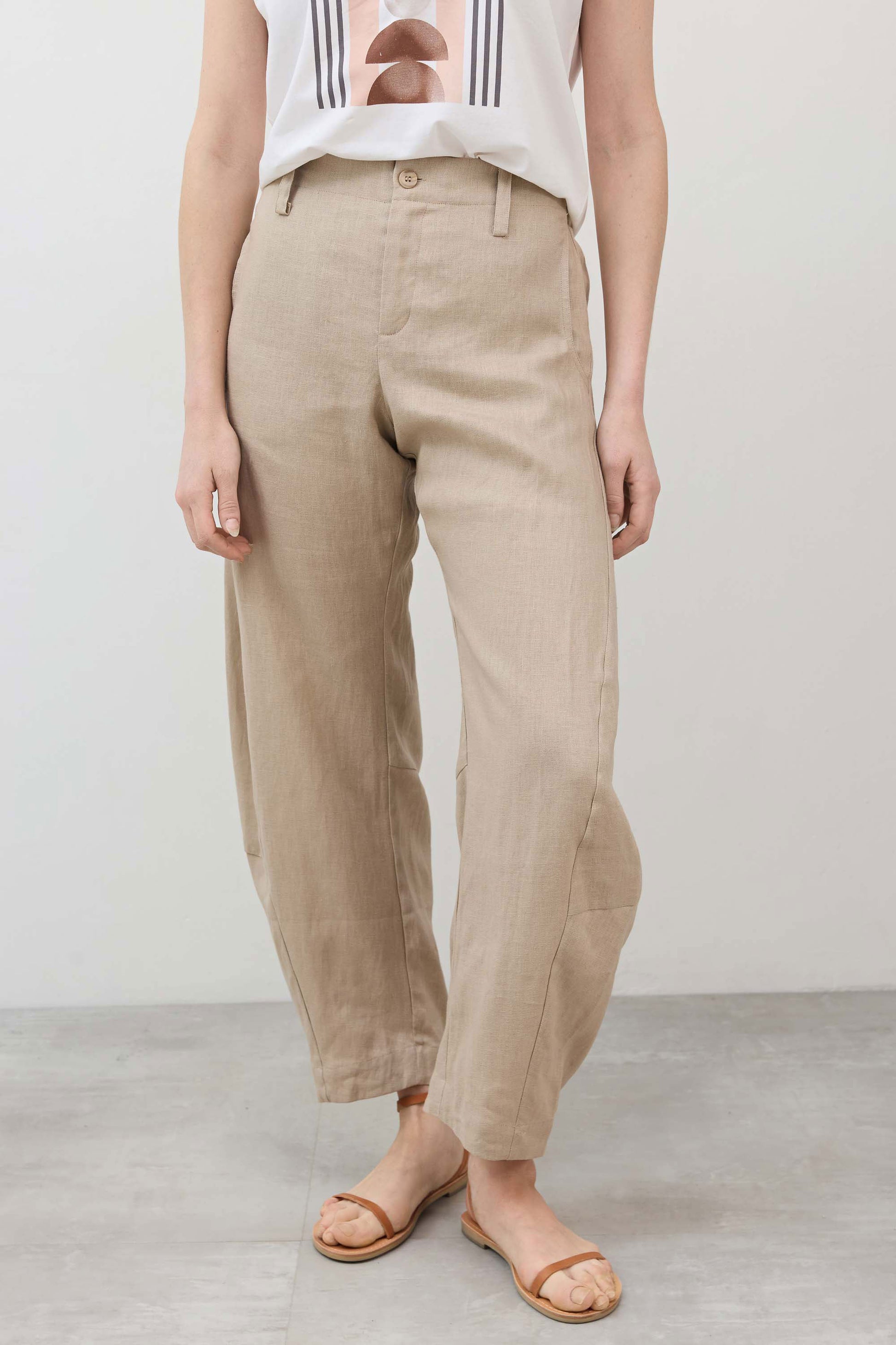 Light beige linen pants with buttoned fly, elastic waist, relaxed tapered legs