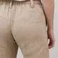 Light beige linen pants close-up, elastic waistband with stitched seam and pocket opening