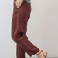 Spice brown linen pants side view with tapered ankle and slant front pocket