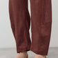 Spice loose linen pants with wide legs, front crease, and side patch pocket