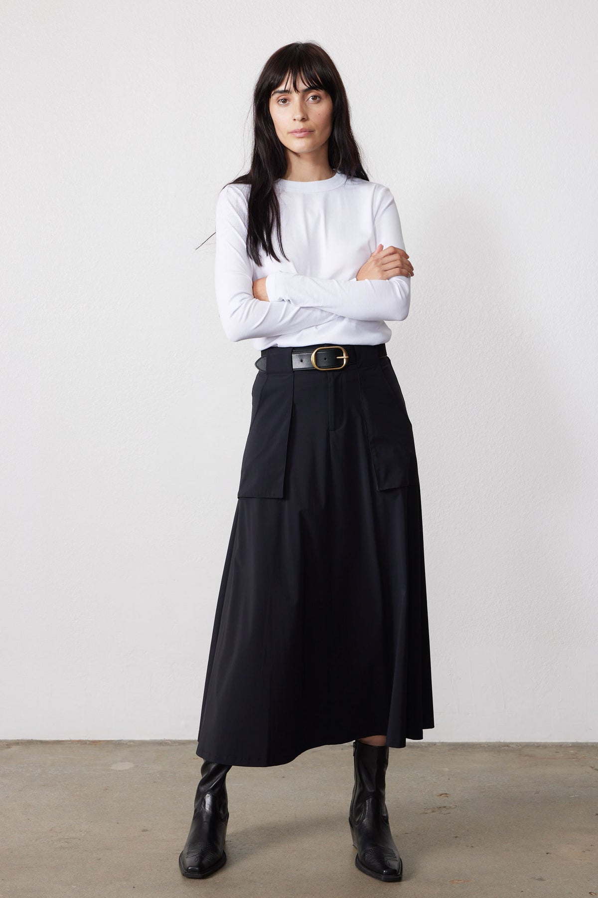 Black utility midi skirt with belt and front flap pockets, cargo-style seams