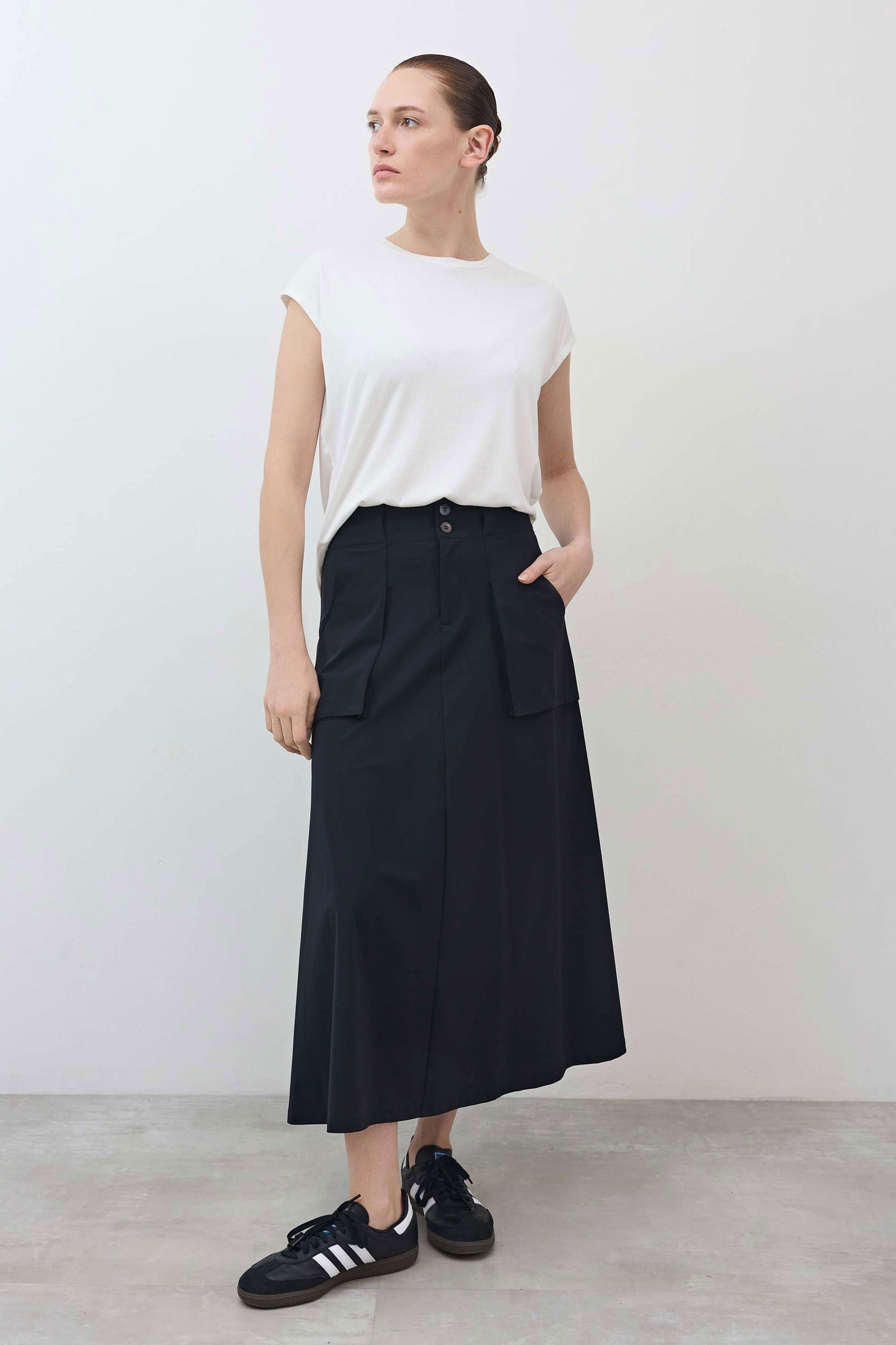 Black utility midi skirt with cargo pockets and button waistband