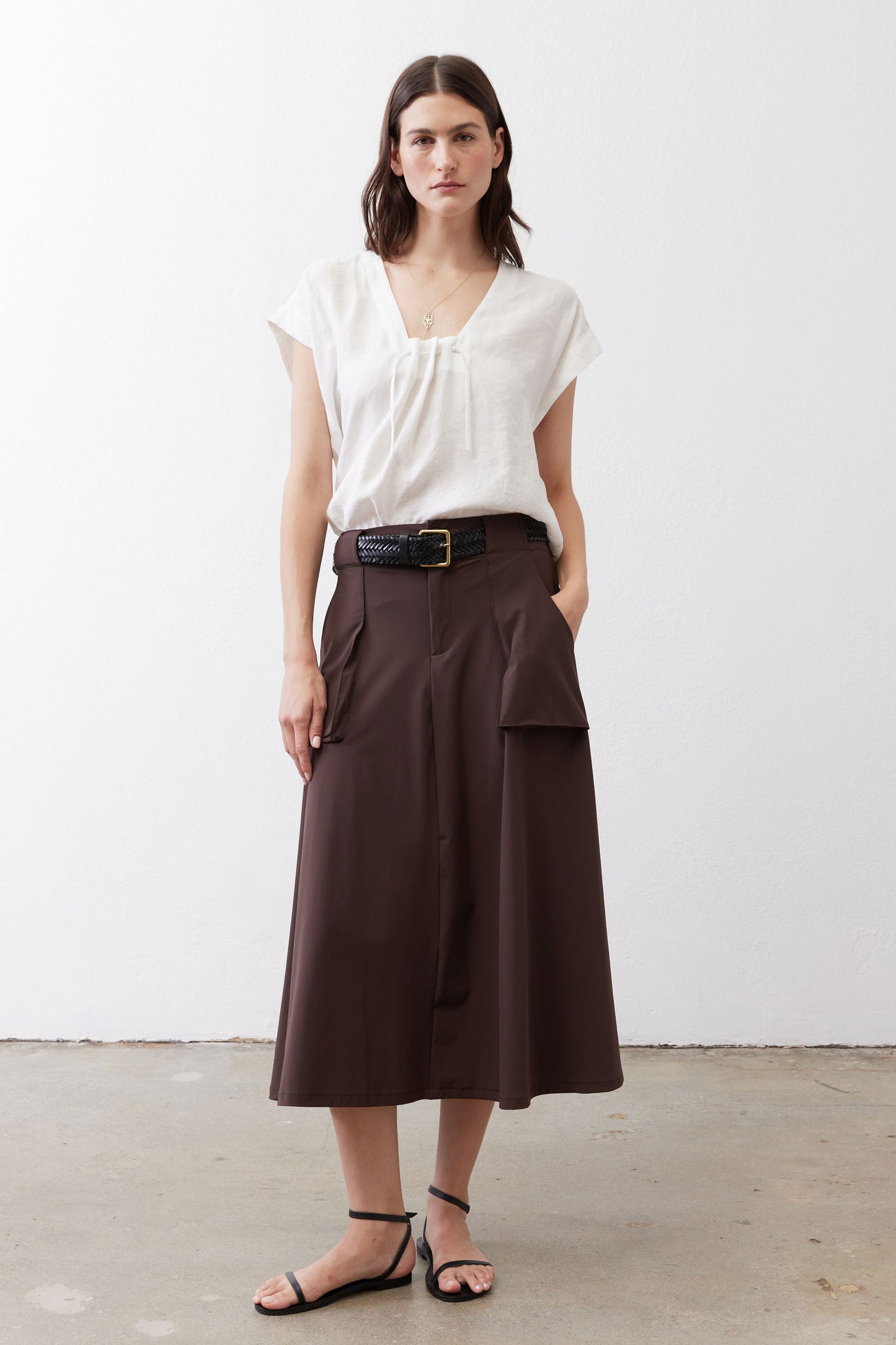 White poplin cinched-neck top with short puff sleeves and drawstring detail