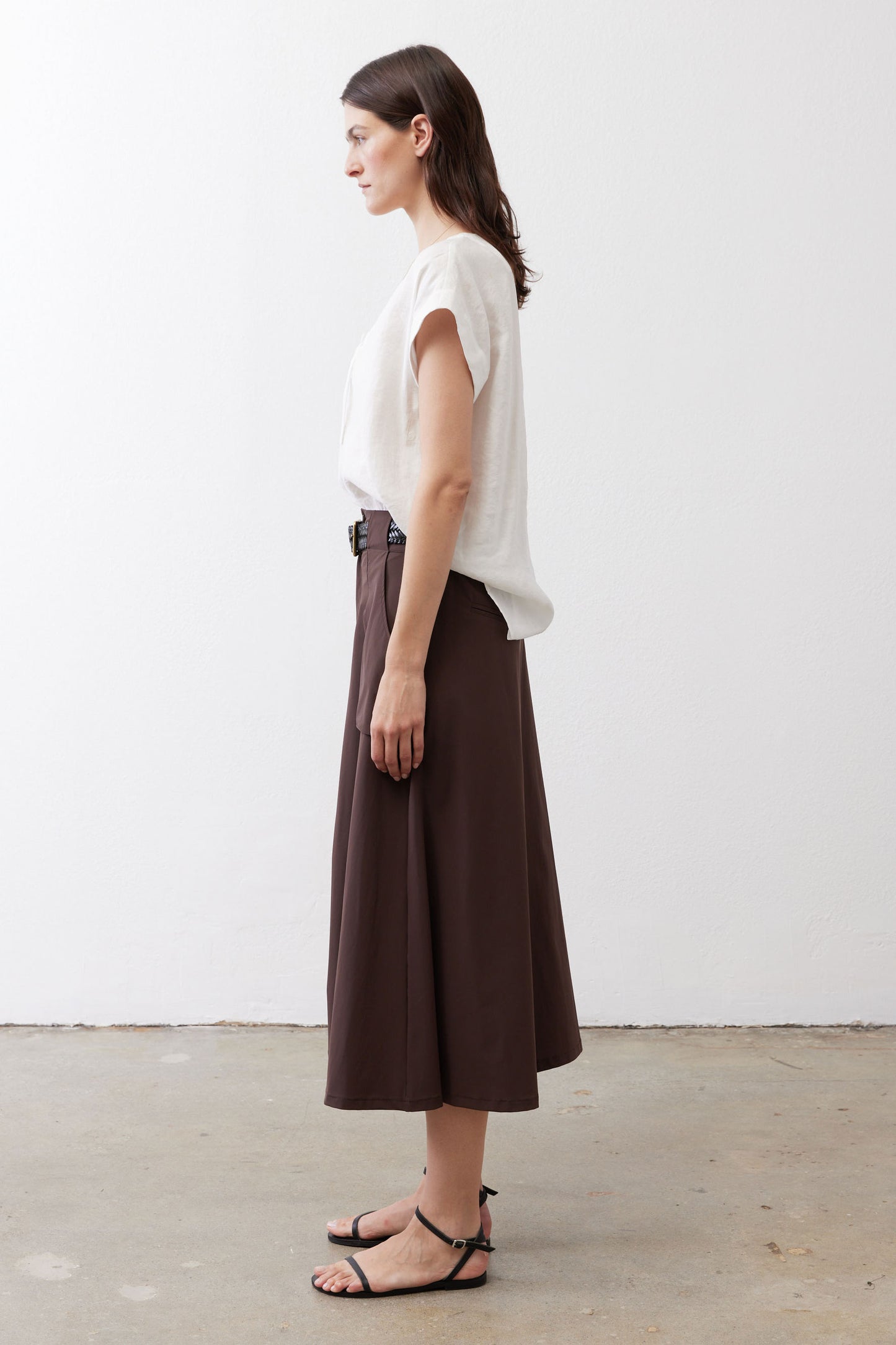 Coffee-brown utility skirt, side view with midi length and button front