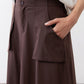 Coffee-brown utility skirt close-up of buttons and flap side pocket