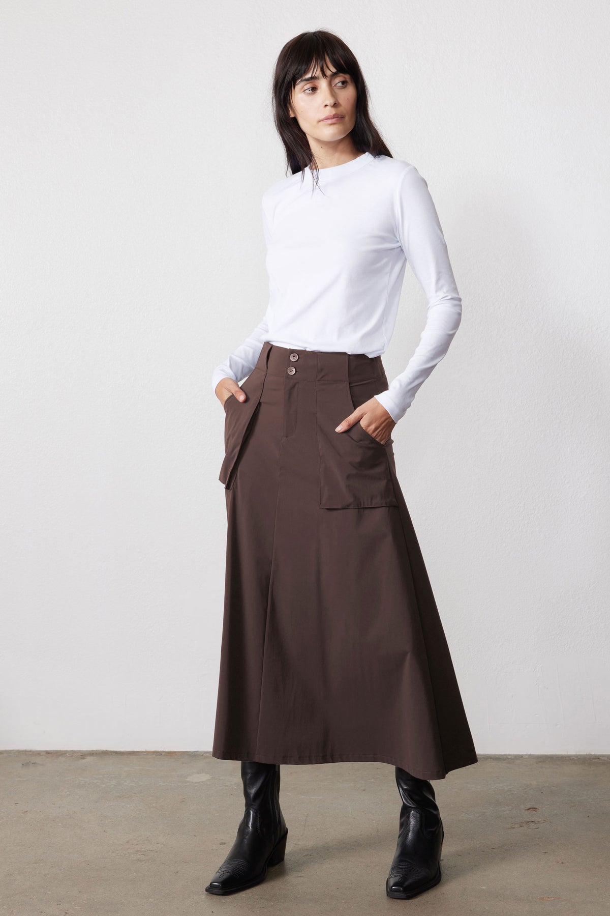Coffee-brown utility skirt with front patch pockets, belt loops, and adjustable belt