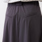 Graphite utility skirt waistband and side pockets, structured panel seam detail.