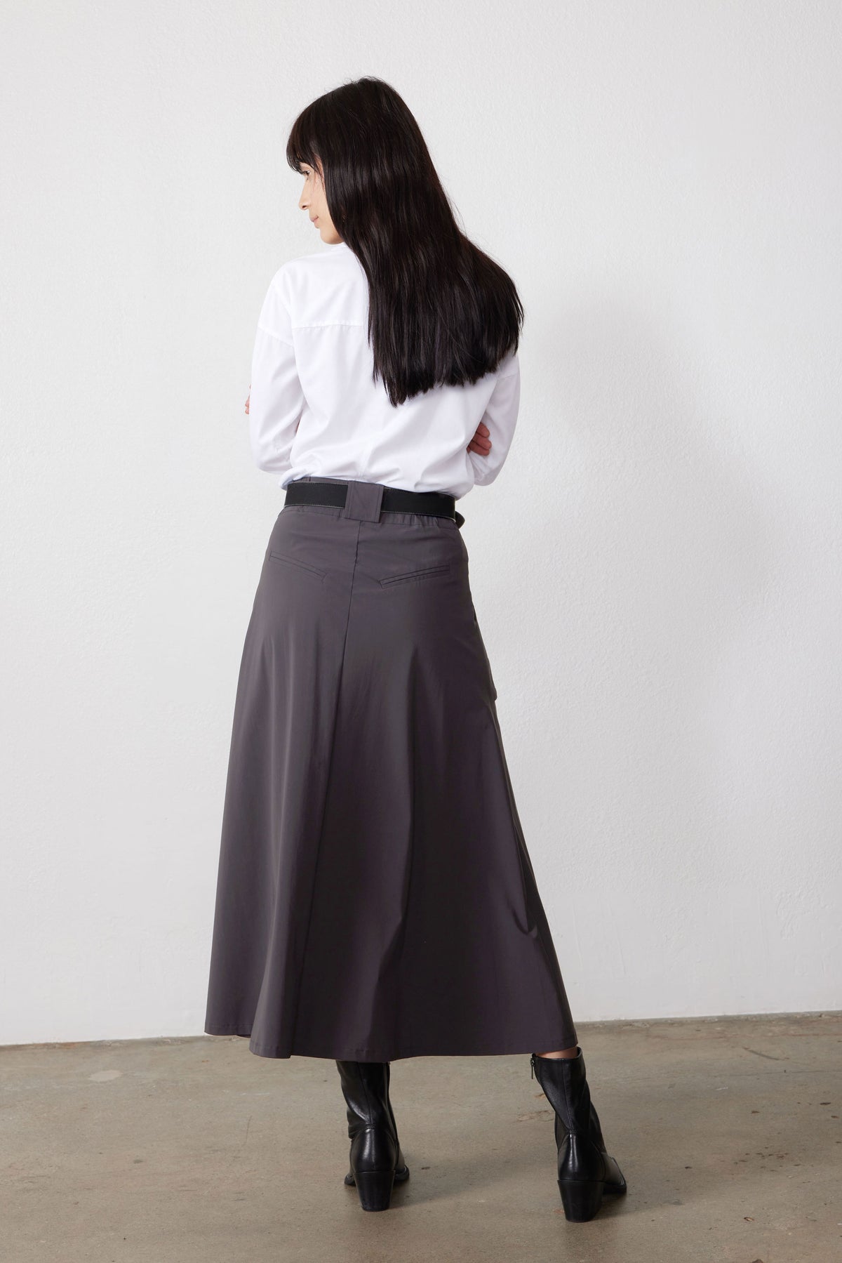 Graphite gray utility midi skirt, back view with waistband and pleated drape