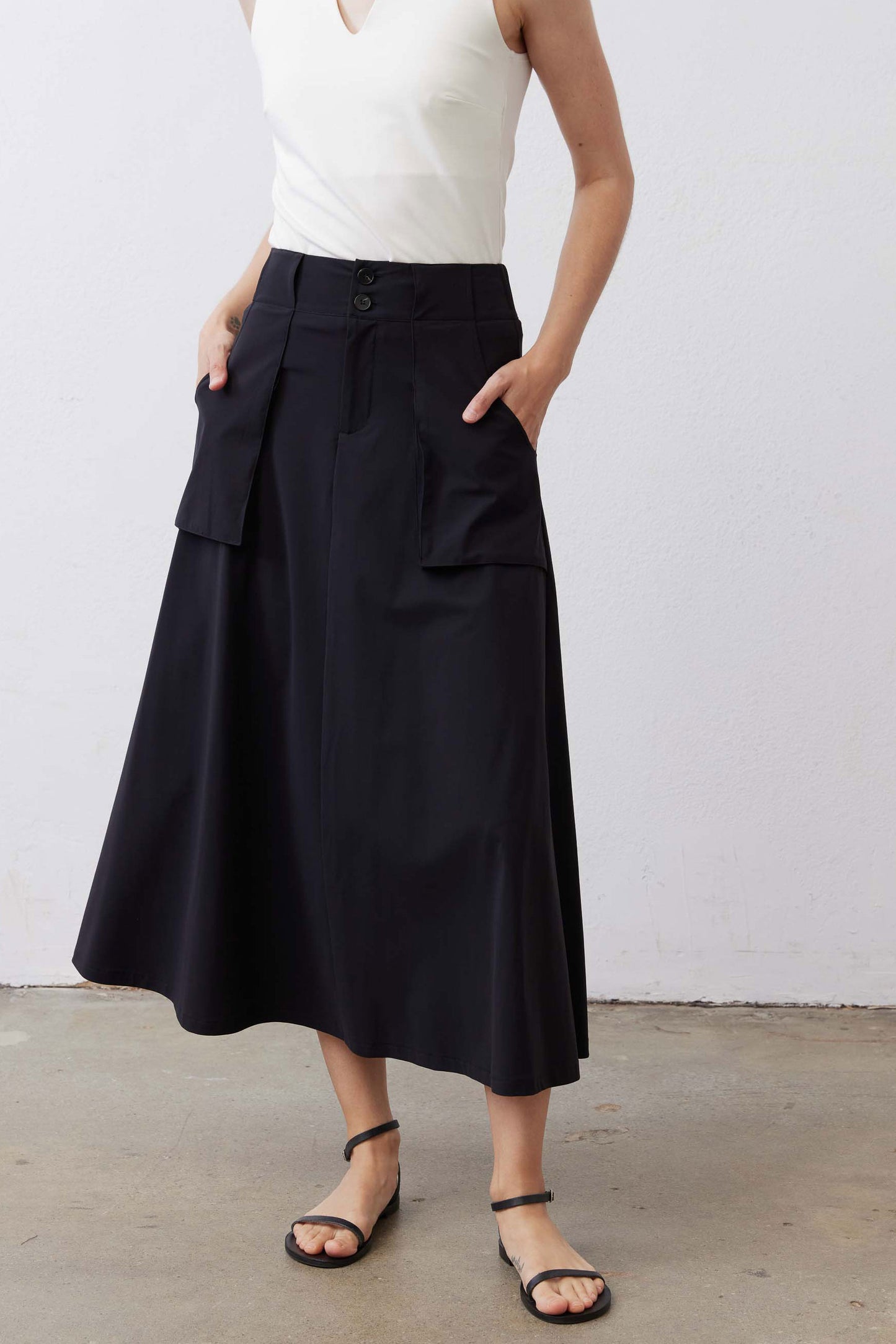 Black utility midi skirt with front buttons and two cargo pockets, A-line silhouette
