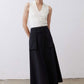 Black utility midi skirt standing view with cargo pockets and buttoned waistband