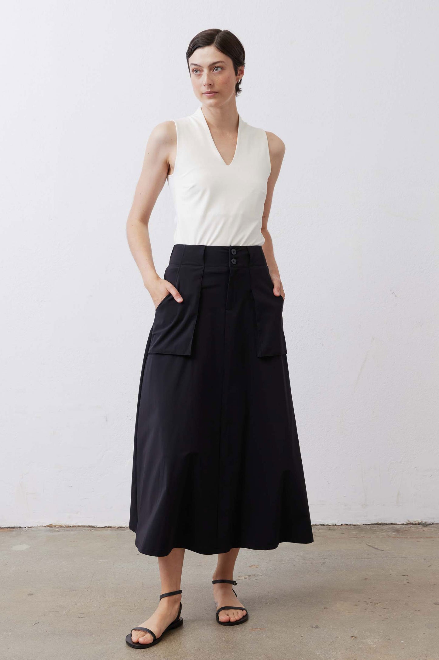 Black utility midi skirt with front buttons and cargo pockets, wide waistband