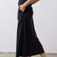Black utility midi skirt with cargo pocket panels and front buttons, side view