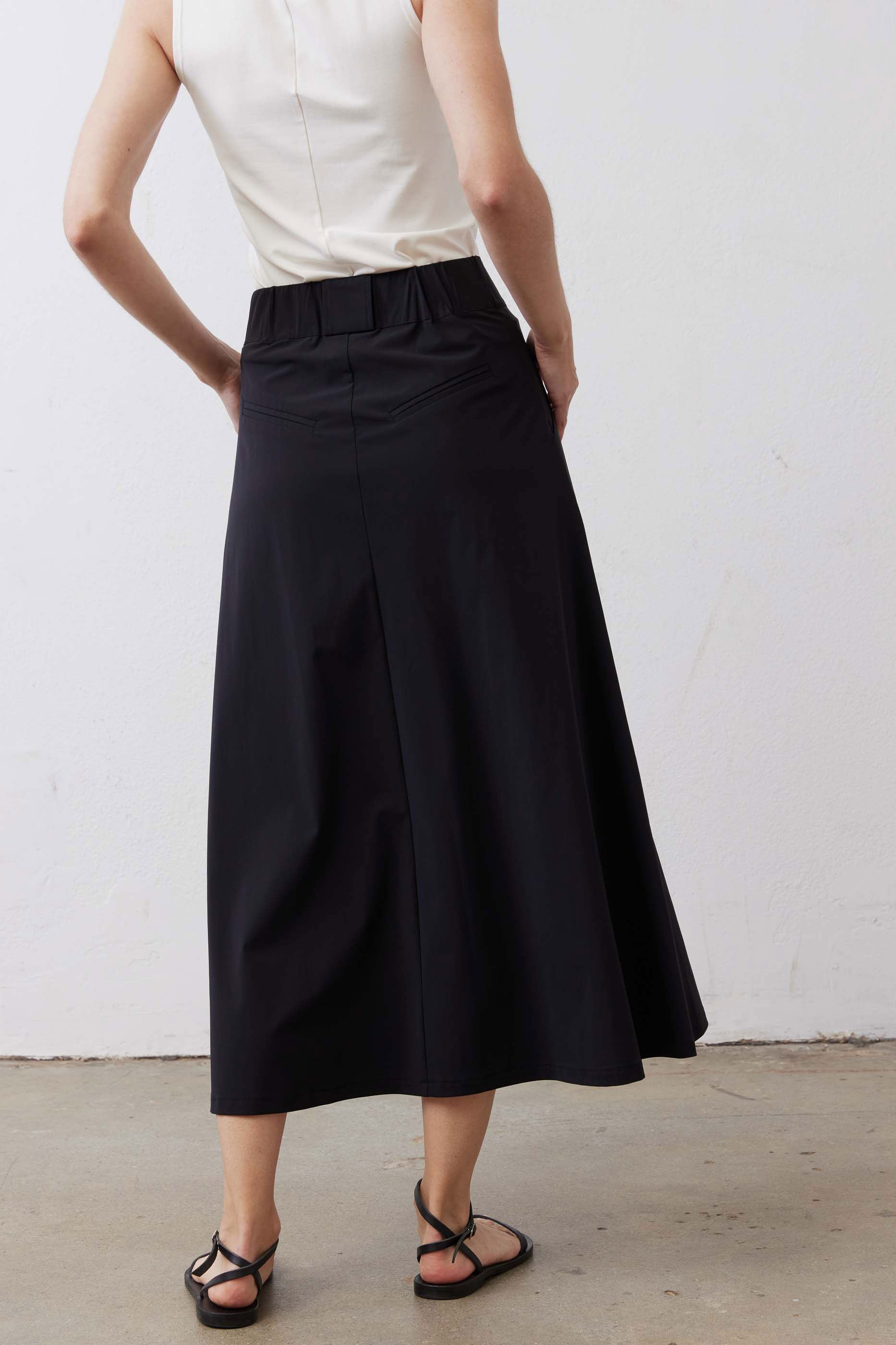 Black utility midi skirt with cargo pockets and flared hem, back view