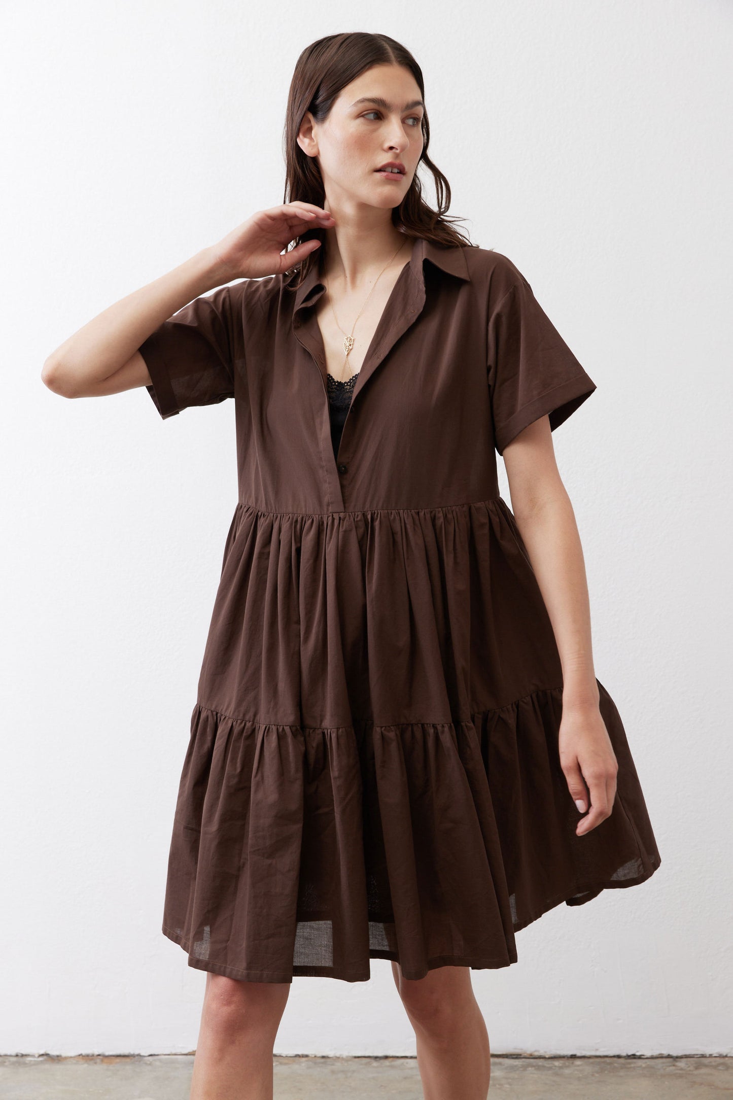 Dark brown poplin dress front with V-neck, short sleeves, and tiered skirt