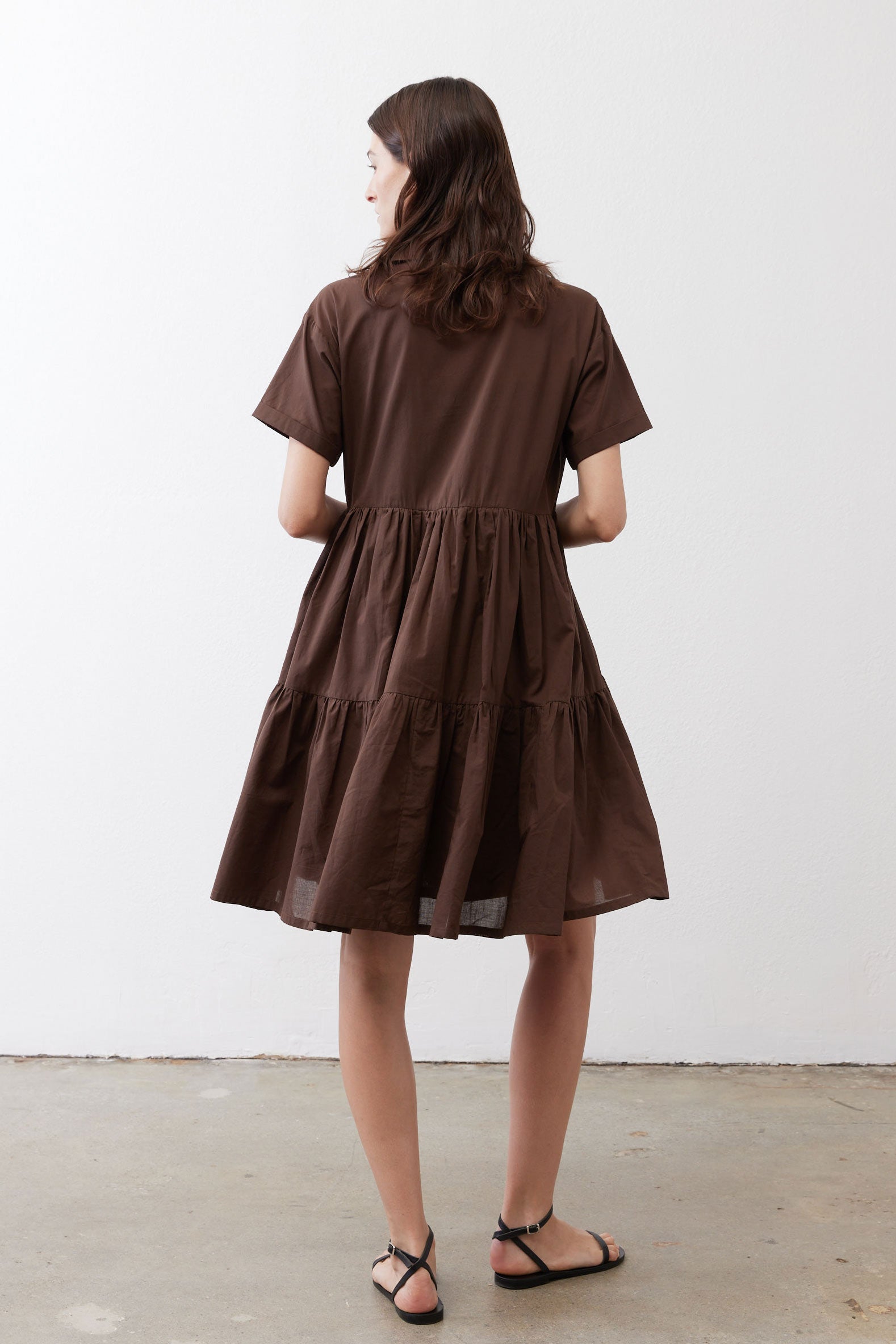 Brown tiered poplin dress back view with short sleeves and gathered waist