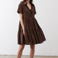 Dark brown poplin dress with V-neck, short sleeves, and tiered skirt