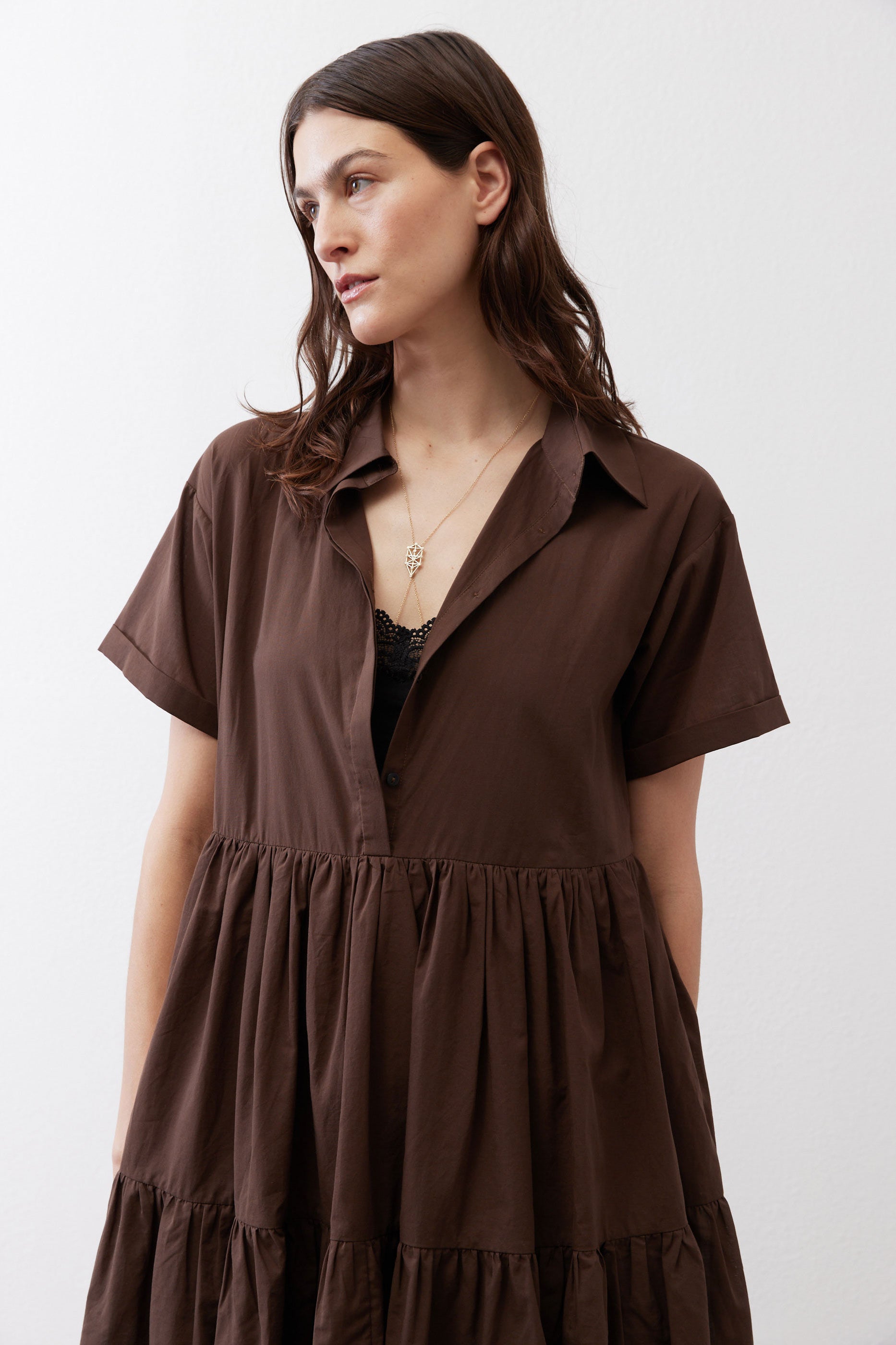 Brown poplin dress with open collar, short sleeves, and tiered ruffle hem