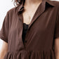 Close-up of dark brown dress: point collar, V neckline, and tiered waist
