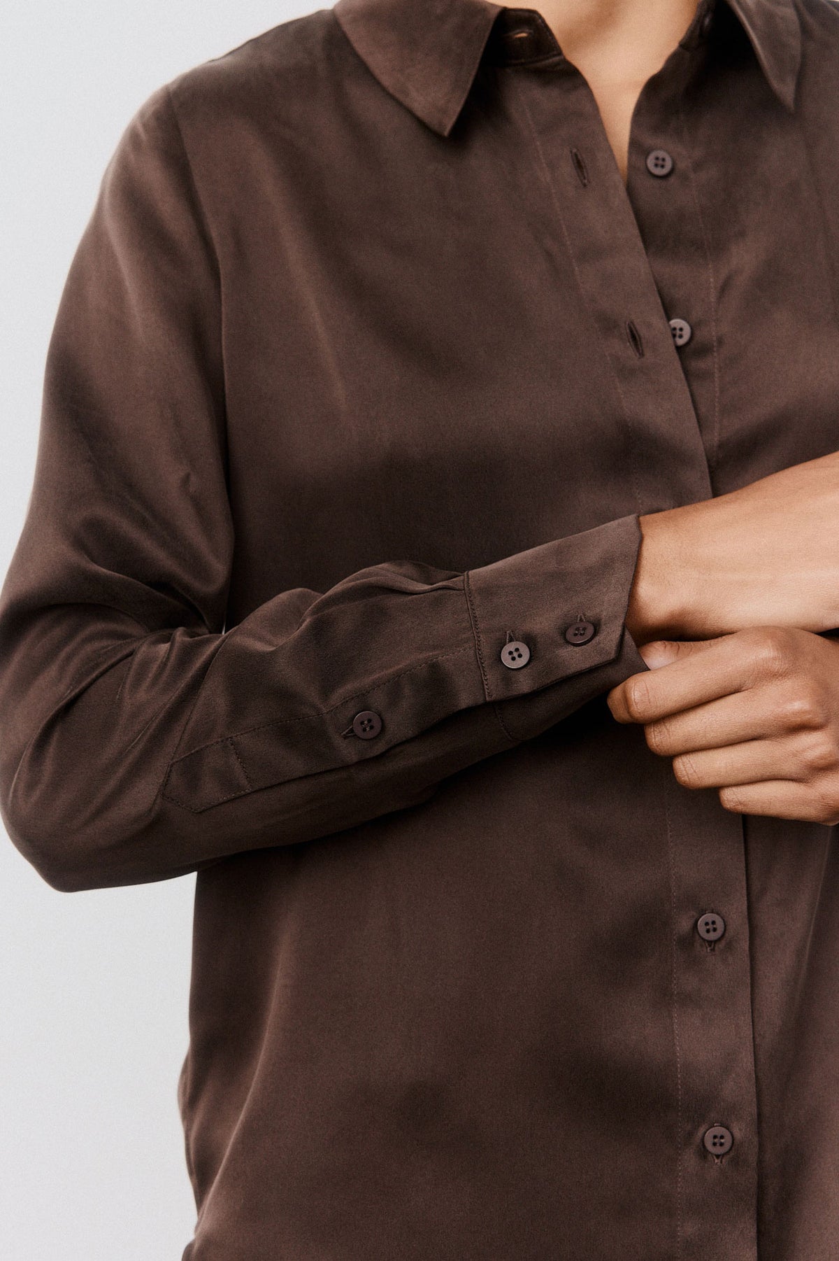 Coffee silk button-down sleeve detail with button cuffs and stitched placket