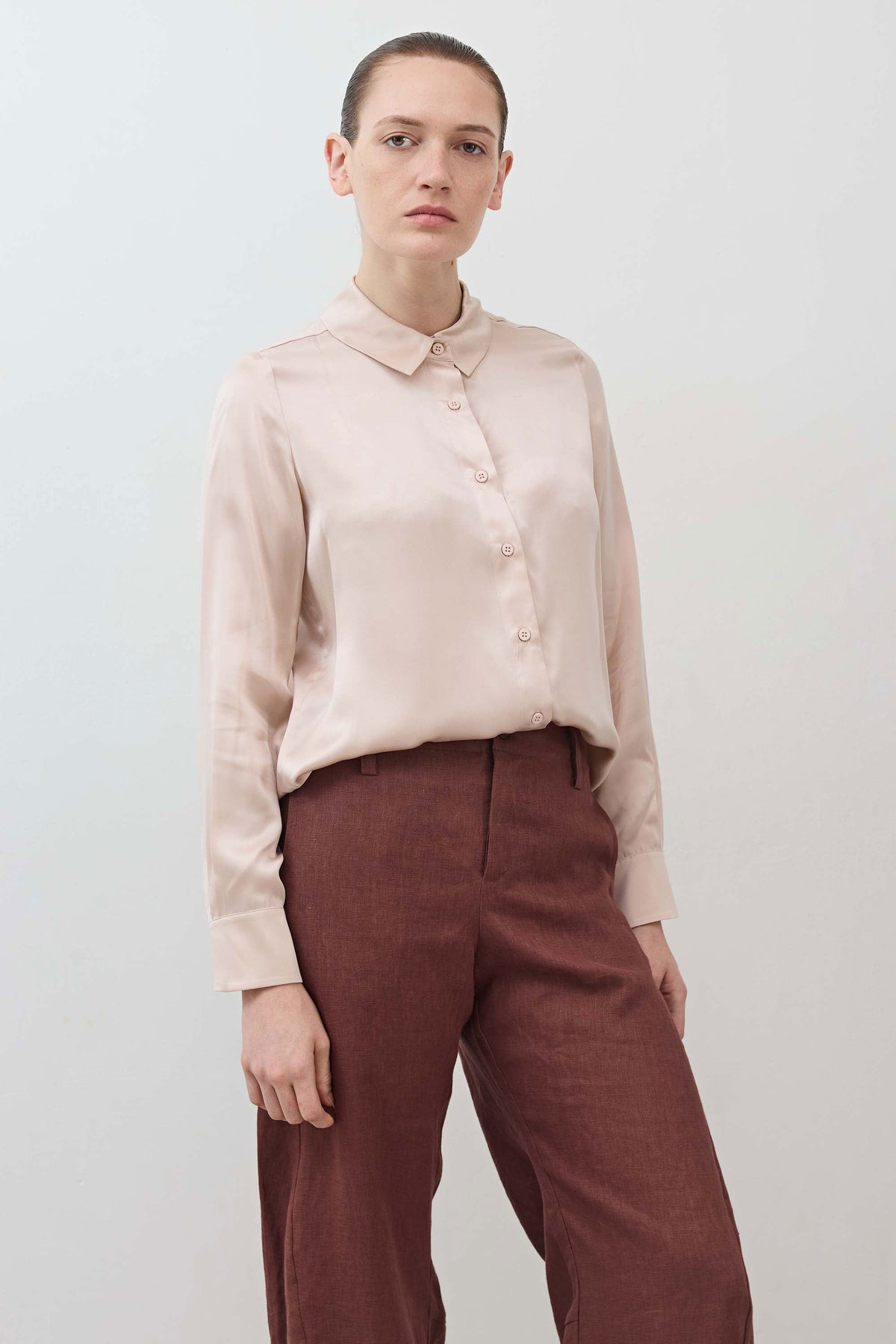 Peach blush silk button-down top with collar, button front, and relaxed fit