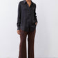Black silk button-down top with pointed collar and button front, long sleeves