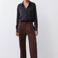 Black silk button-down top with pointed collar and button front, relaxed fit