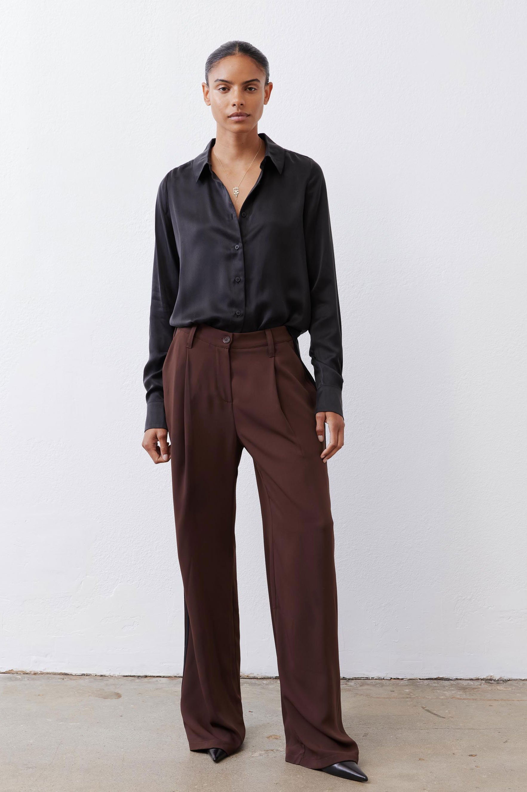 Black silk button-down top with pointed collar and button front, relaxed fit