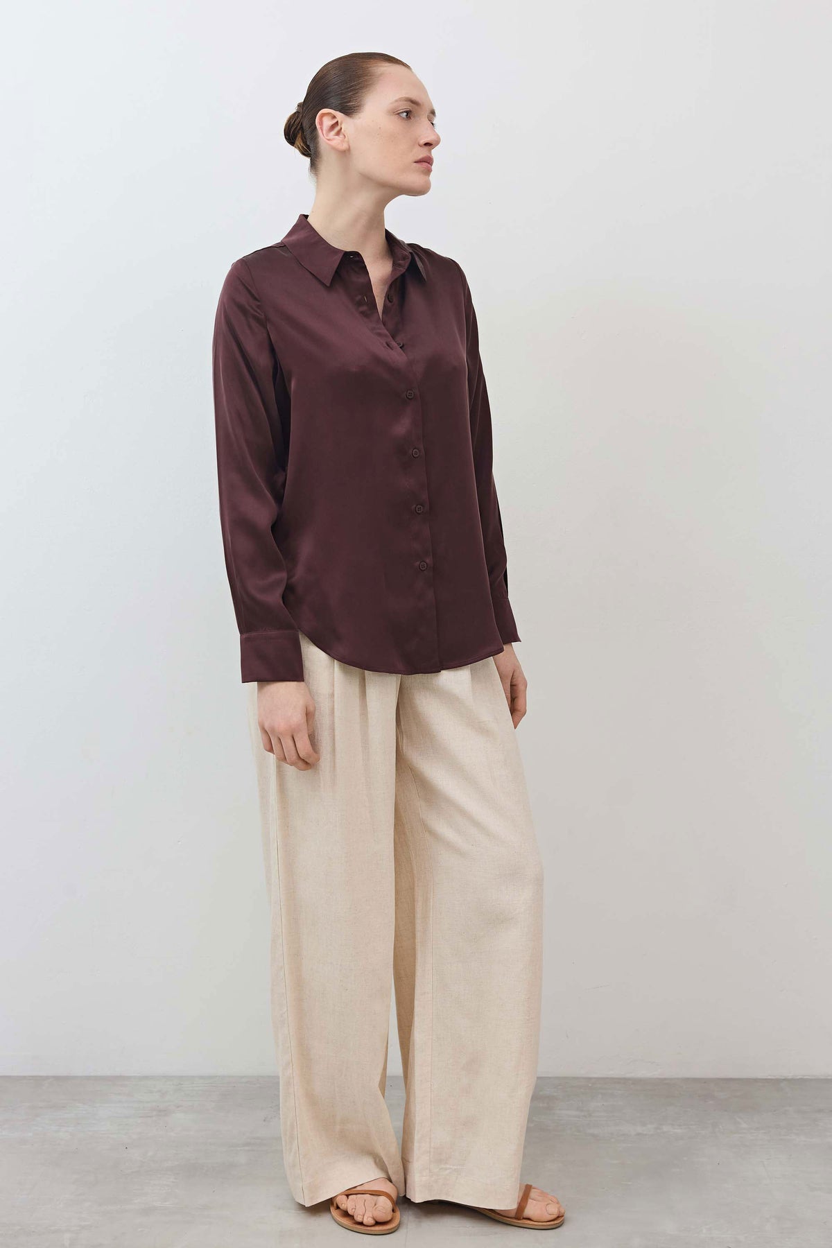 Dark plum button-down shirt with pointed collar, long sleeves, and button placket