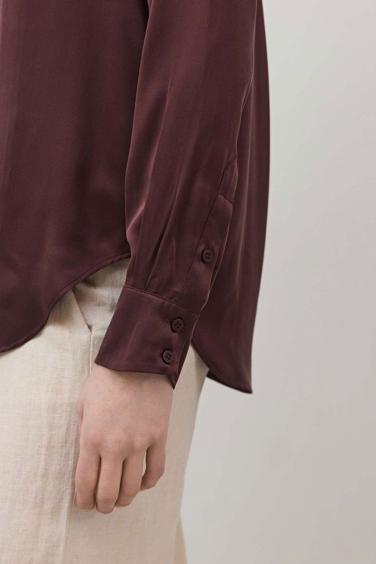 Dark plum silk button-down sleeve cuff with two-button closure