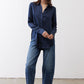 Dark blue silk button-down top with long sleeves and front button placket