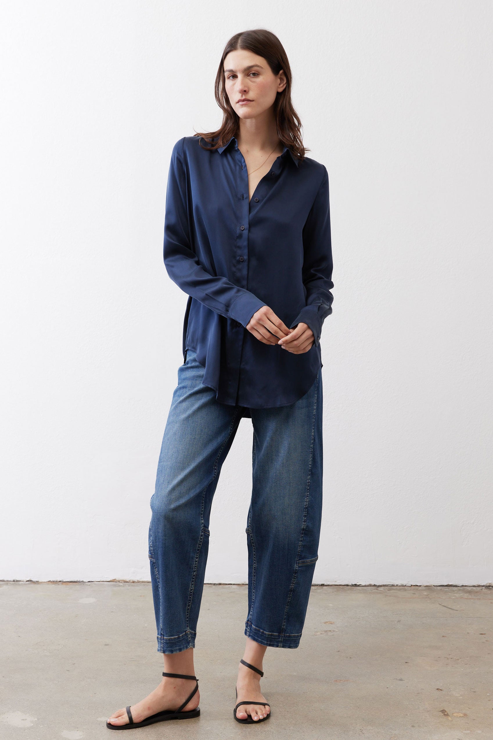 Dark blue silk button-down top with long sleeves and front button placket