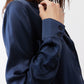 Dark blue silk button-down top close-up: collar and dark buttons