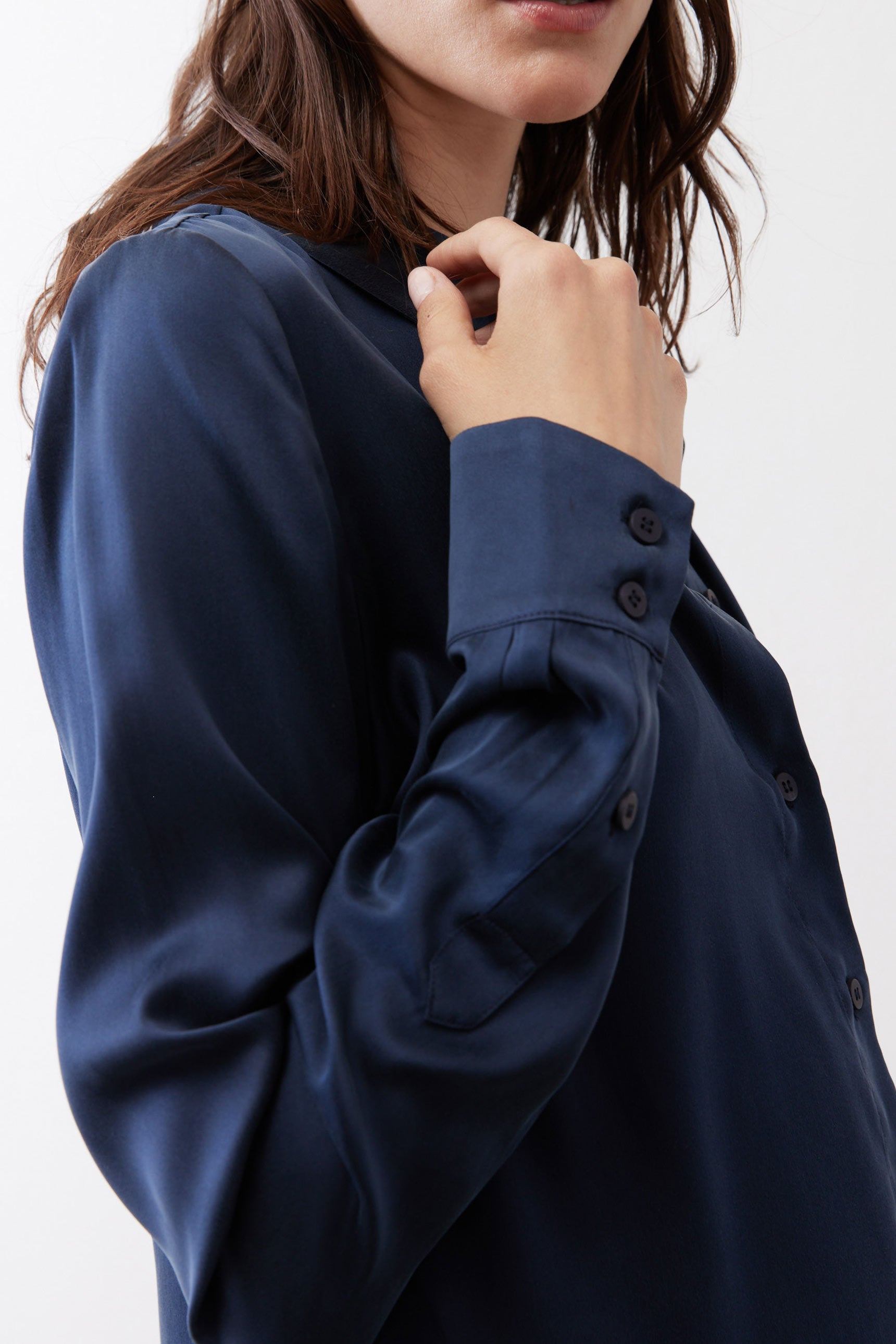 Dark blue silk button-down top close-up: collar and dark buttons