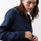 Dark blue silk button-down top close-up of cuffs and front buttons