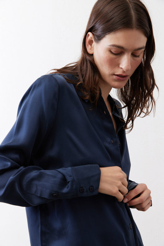 Dark blue silk button-down top close-up of cuffs and front buttons