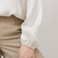 Ivory silk blouse sleeve with gathered cuff