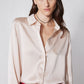 Peach blush silk button-down top with long sleeves and front buttons