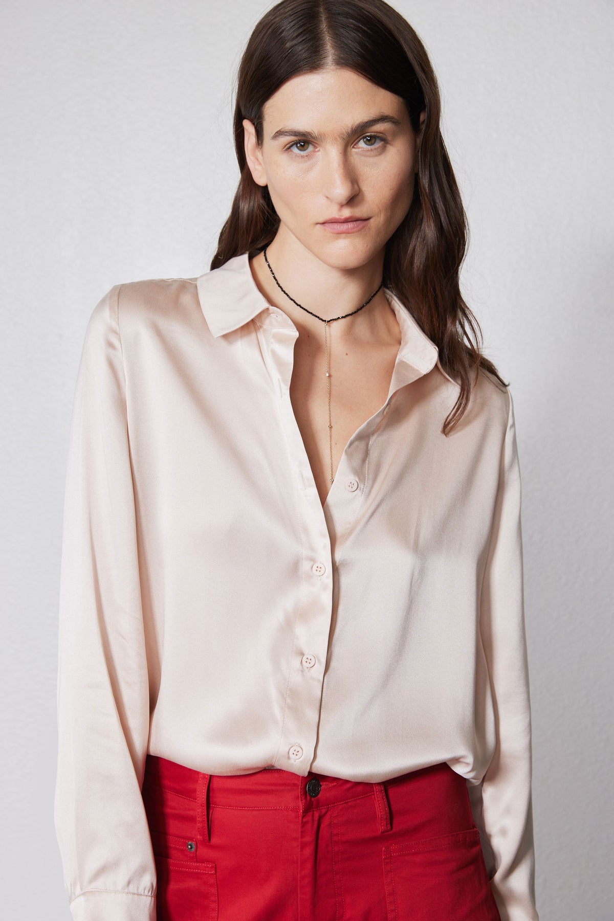 Peach blush silk button-down top with long sleeves and front buttons