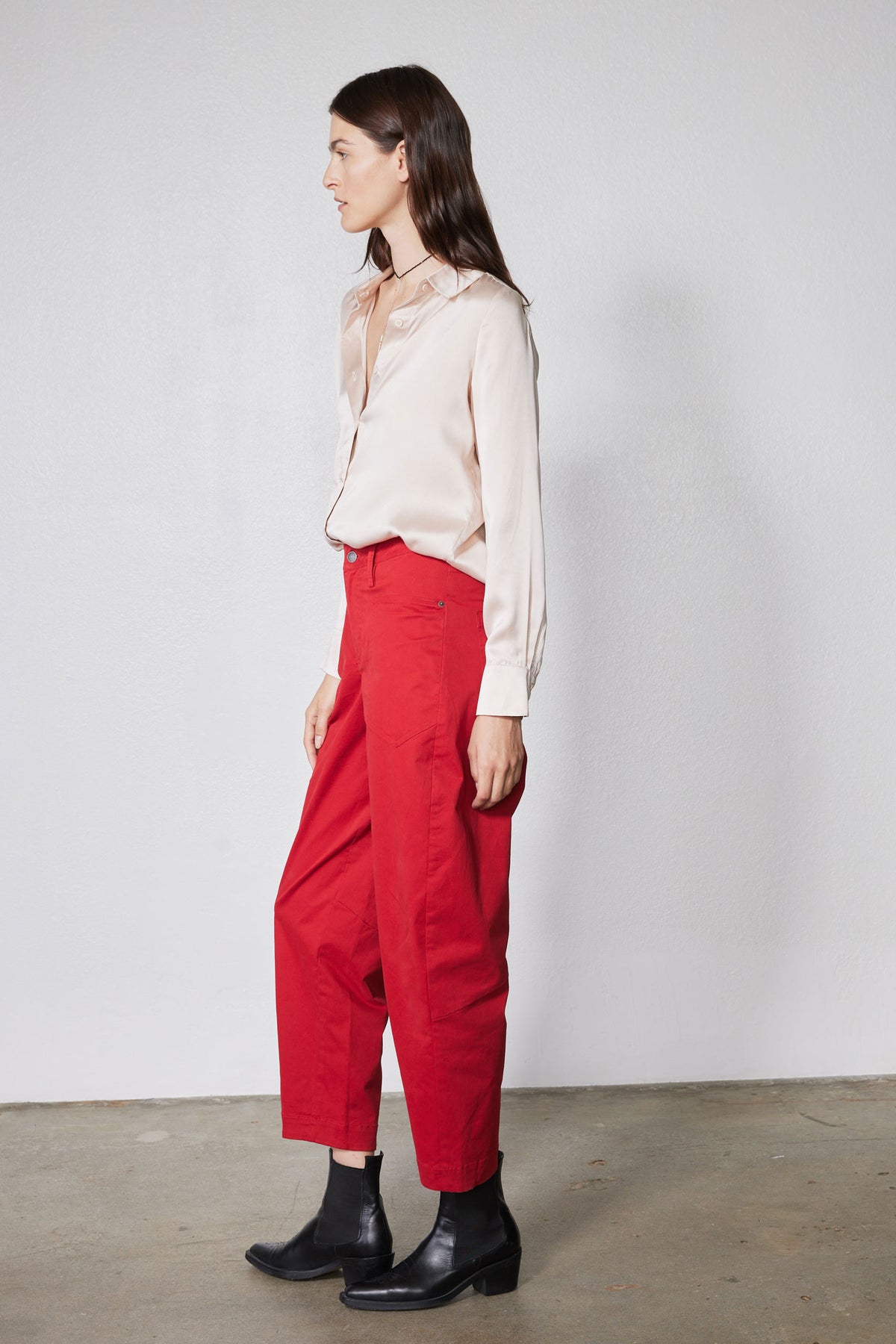 Peach blush silk button-down top with cuffs and front buttons, side view