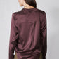 Deep plum silk button-down top, long sleeves, back view with draped yoke