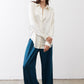 Ivory silk button-down top with pointed collar and front button placket