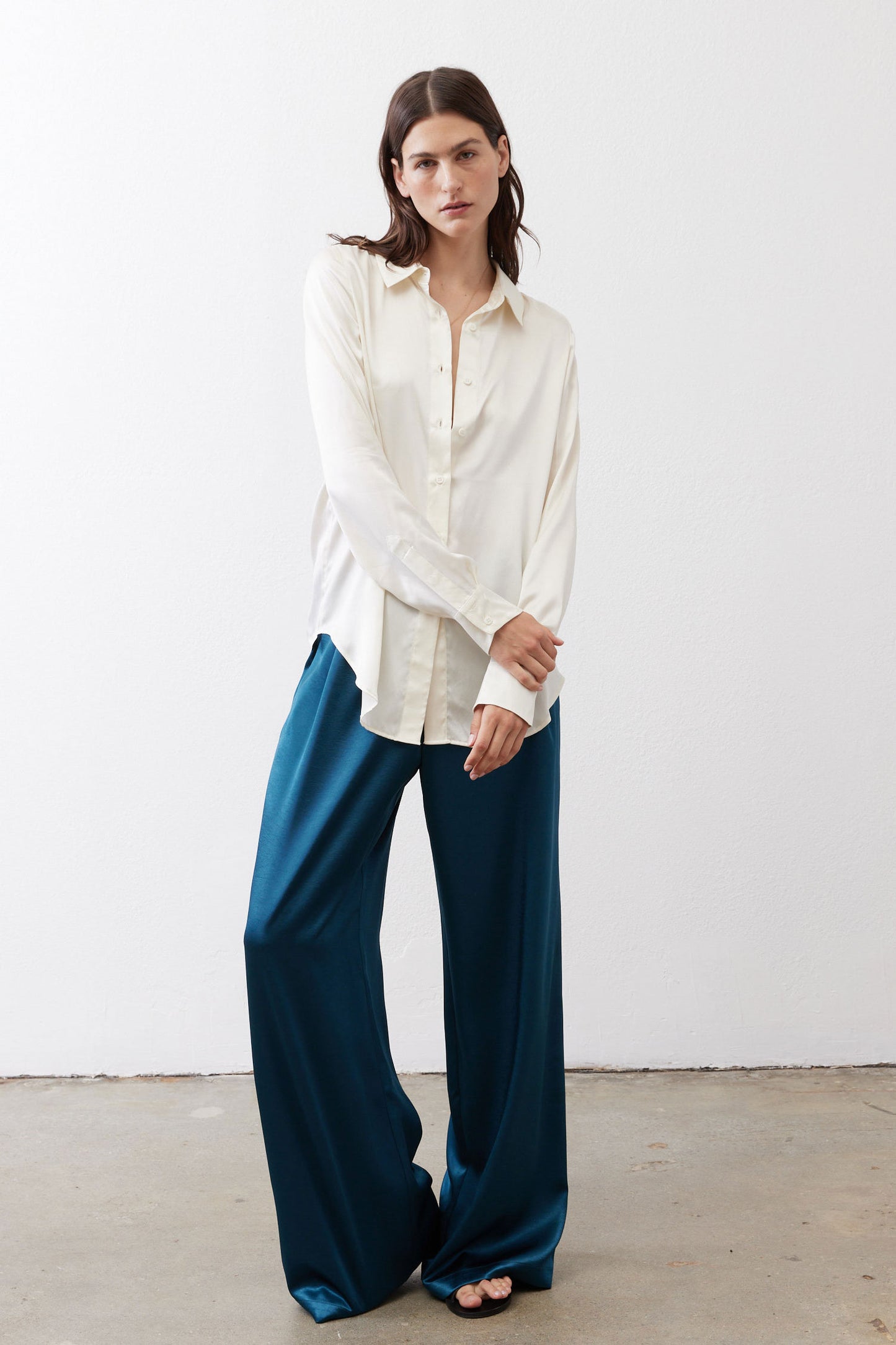 Ivory silk button-down top with pointed collar and front button placket