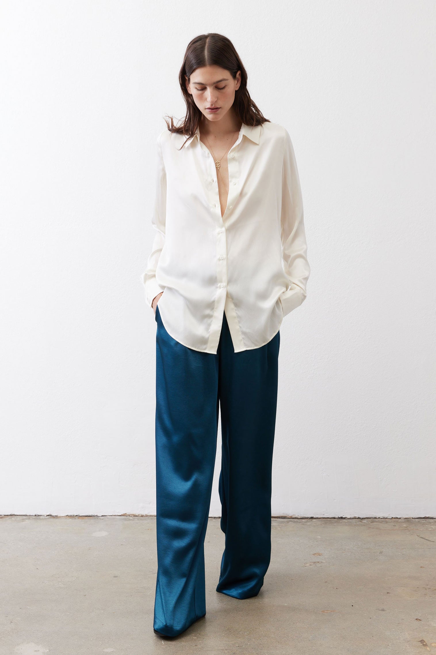 Ivory silk button-down top with long sleeves and open front placket