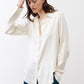 Ivory silk button-down top with stand collar and button front detail