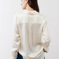 Ivory silk button-down top back view with yoke seams and long sleeves