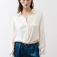 Ivory silk button-down top with pointed collar and button-front closure