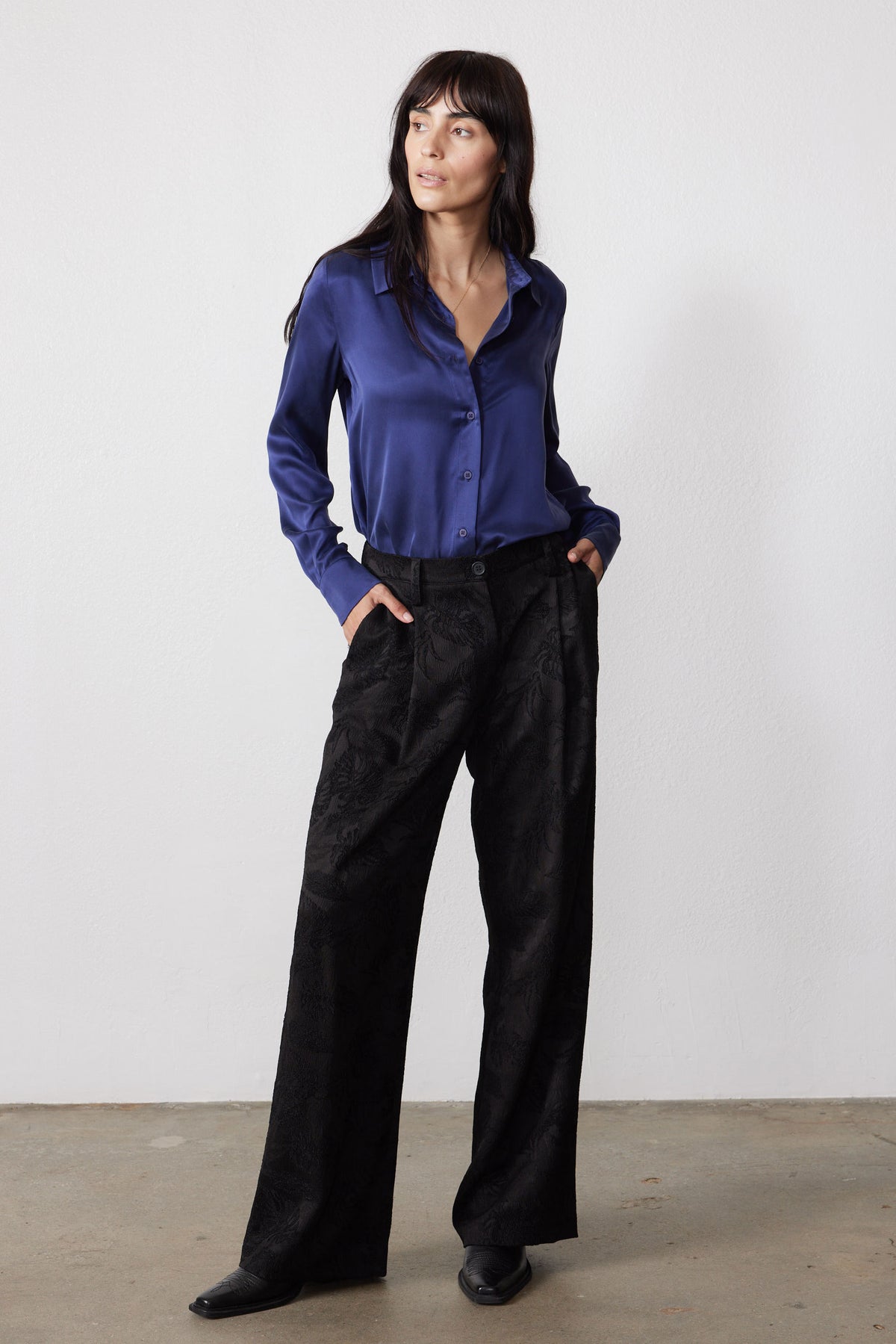 Blue washable silk button-down shirt with a pointed collar and long sleeves, shown with black pants.