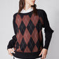 Black argyle sweater with rust diamond pattern and long sleeves, crew neck